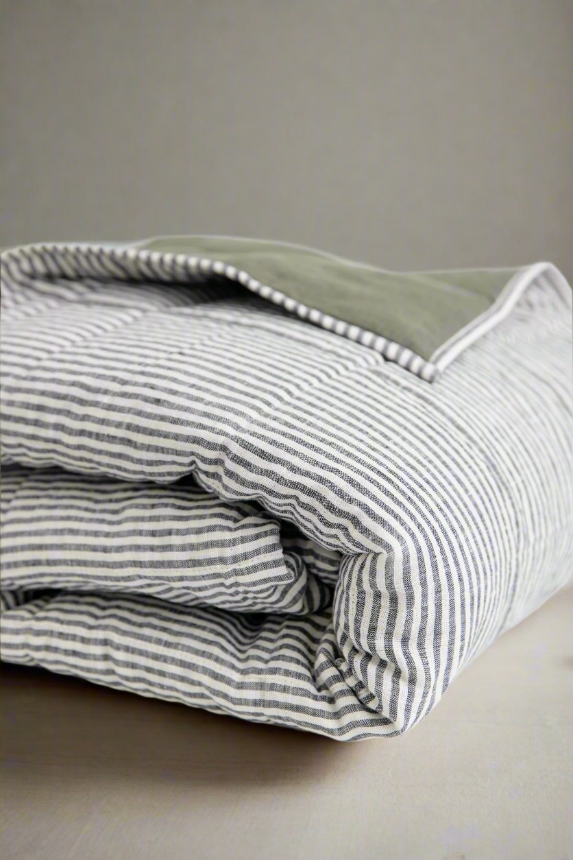 Curated mix of stonewashed linen sheets and pillowcases in muted earthy tones. #color_moss-stripe