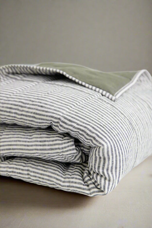 Curated mix of stonewashed linen sheets and pillowcases in muted earthy tones. #color_moss-stripe