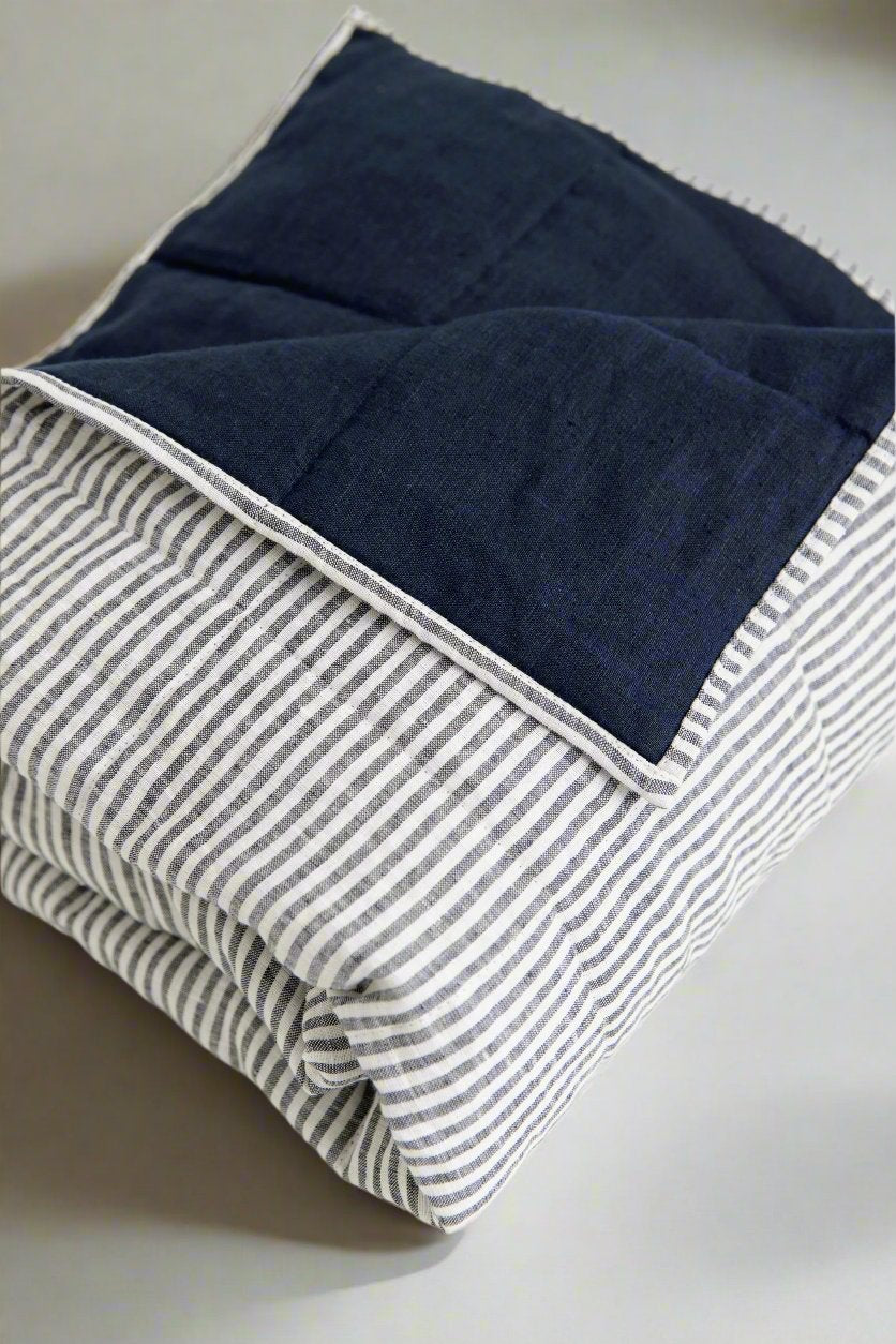 Stonewashed European linen bedding in soft natural tones, styled on a modern bed. #color_navy-stripe