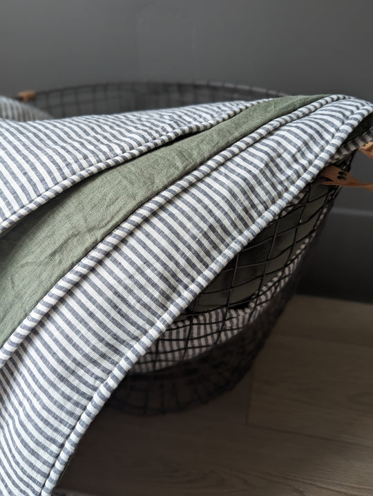 Curated mix of stonewashed linen sheets and pillowcases in muted earthy tones. #color_moss-stripe